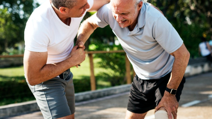 man assisting old man in pain