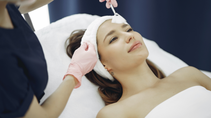 woman lying on the clinic bed getting facials